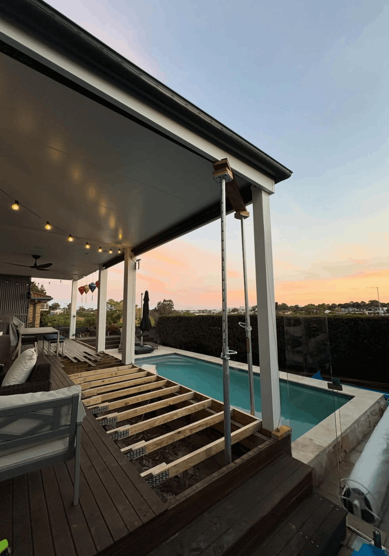 Poolside deck frame in progress at sunset