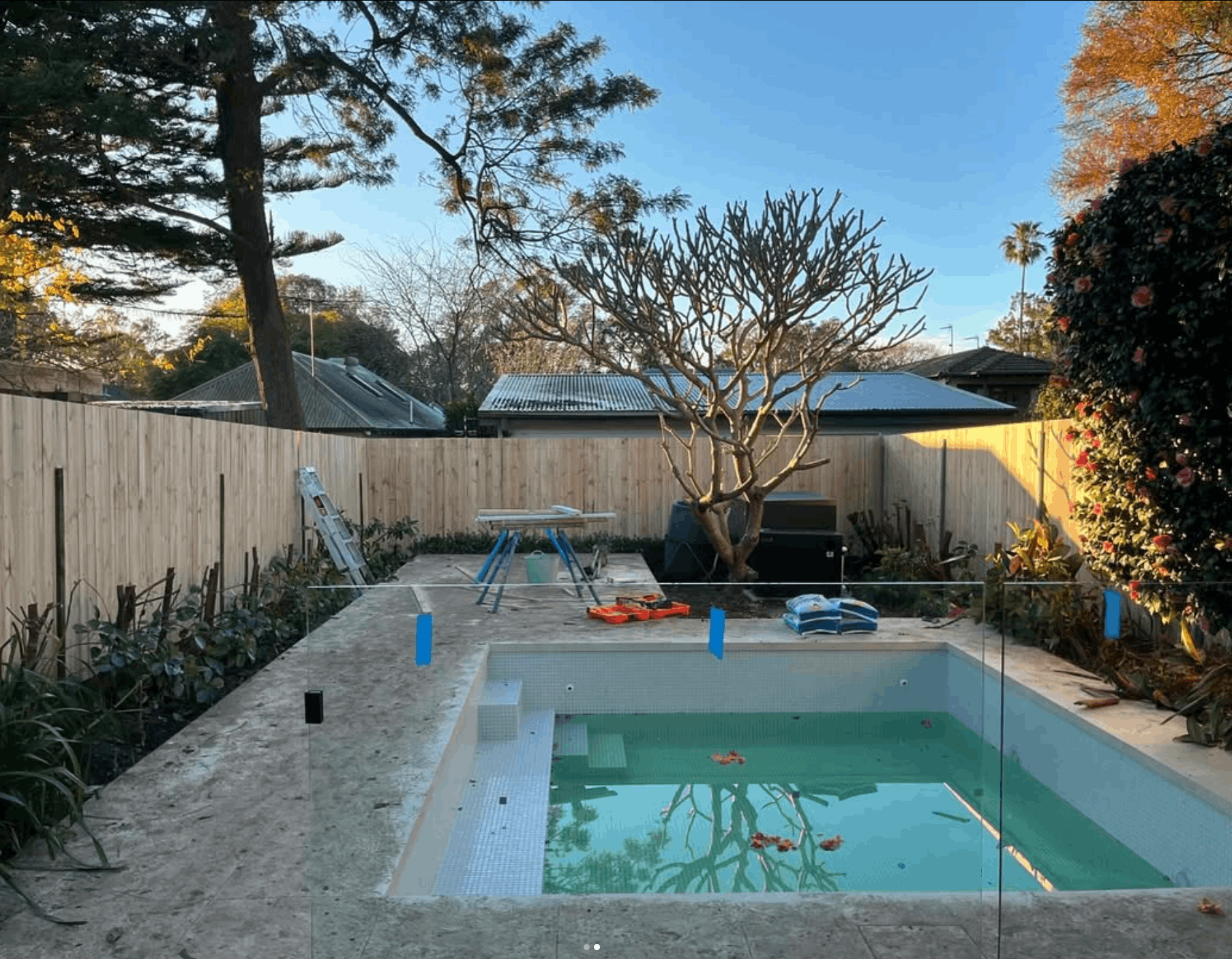 Pool surround with glass fencing and stone coping